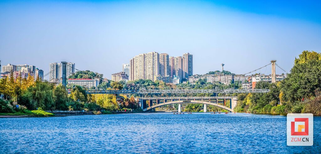 冬日的暖陽(yáng)灑在樹木和建筑上，河道靜靜流淌著，寧?kù)o而美麗.jpg