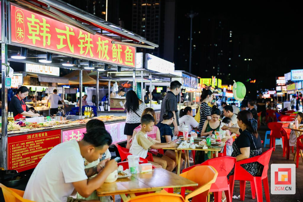 食客围桌品尝小吃,各式摊位灯火绵延,勾勒自贡夜市热闹鲜活的人间烟火。 记者 宋姿熠 摄.jpg