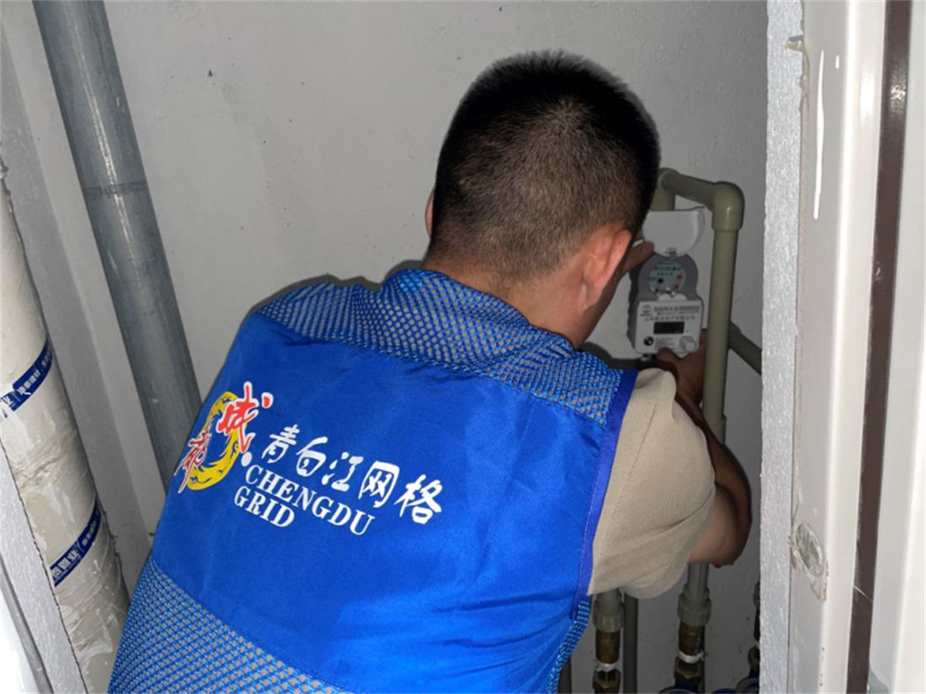 社区工作人员正在查看智能水表（新峰社区供图）.jpg